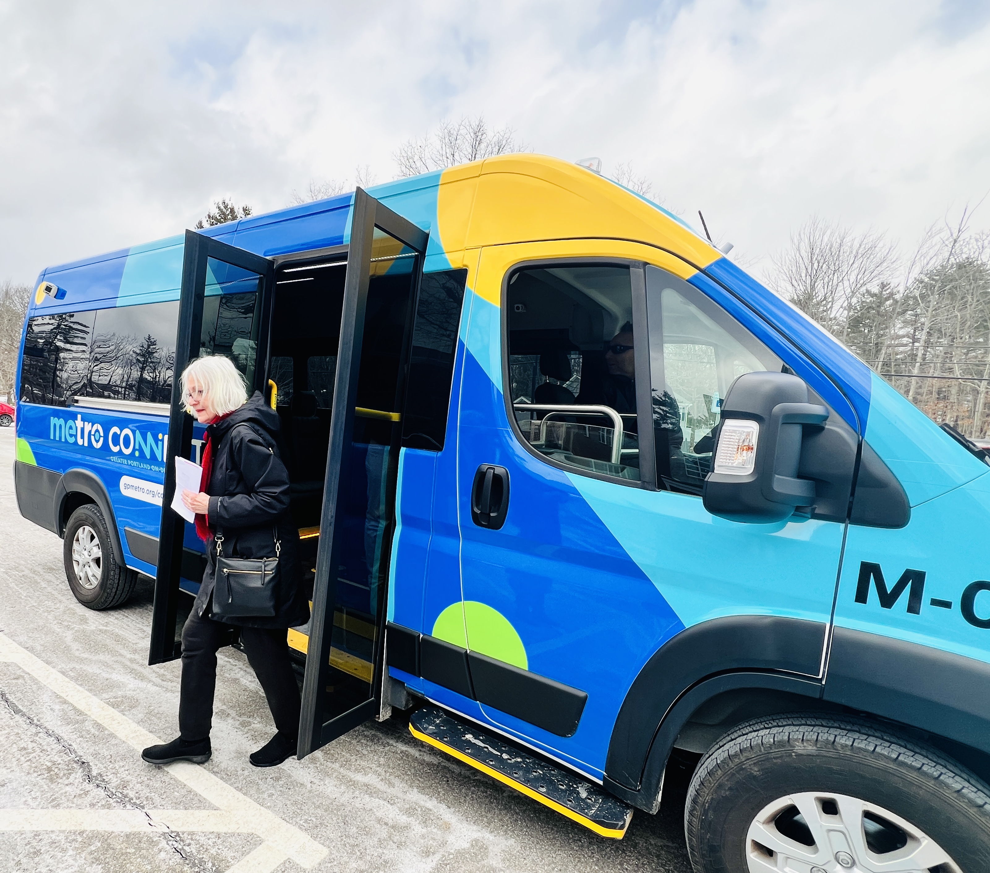 Elderly woman getting off a Metro Connect van